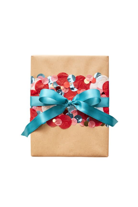 <p><strong>What you'll need:</strong></p><p>● Pencil</p><p>● Paintbrush</p><p>● Decoupage glue</p><p>● Confetti dots in various colors</p><p>● Blue ribbon</p><ol><li>Wrap your box, then use a pencil to mark where you want the confetti band to go (this one goes across the front and two sides of the box).</li><li>Brush decoupage glue onto the paper using the markings you made as a guide. Completely cover with the confetti, pressing it into the glue. Repeat on the box sides. Wrap with the ribbon and tie into a bow.</li></ol>