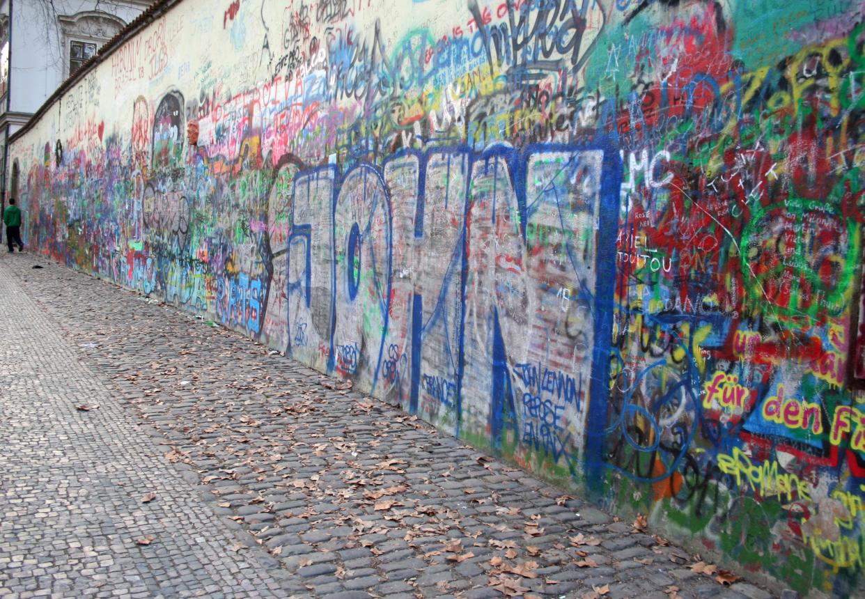 Image of John Lennon Wall in Prague, Czech Republic.  This wall has been graffitied many times over by people from all over the world passing through wanting to honor John Lennon.