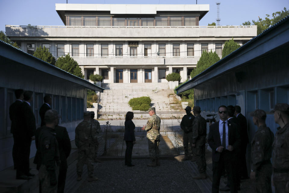 U.S. Vice President Kamala Harris, center left, stands next to the demarcation line at the demilitarized zone (DMZ) separating the two Koreas, in Panmunjom, South Korea Thursday, Sept. 29, 2022. (Leah Millis/Pool Photo via AP)