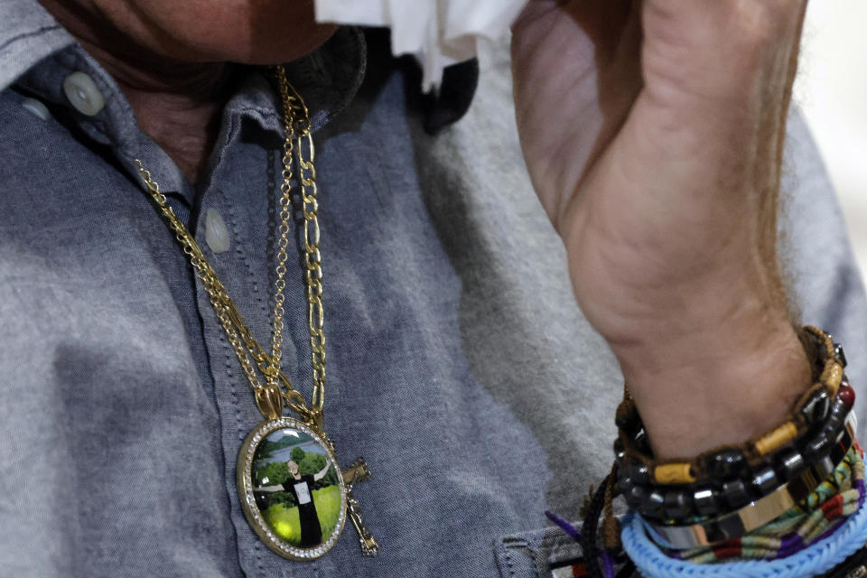 Robert Moberg, wears a pendant bearing a photograph of his son, Corbin, during a news conference at the Broward Public Defender's Office in Fort Lauderdale, Fla., Thursday, Feb. 1, 2024. On January 1, 2024, Corbin Moberg, who had been at the Broward County Jail for two and a half years on drug related offenses, died of an alleged drug overdose. According to Public Defender Gordon Weekes, there have been 21 deaths in the jail since 2019. (Amy Beth Bennett/South Florida Sun-Sentinel via AP)