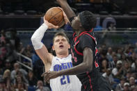 Orlando Magic's Moritz Wagner (21) shoots against Toronto Raptors' Chris Boucher during the second half of an NBA basketball game Friday, Dec. 9, 2022, in Orlando, Fla. (AP Photo/John Raoux)