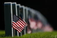 <p>Decorated to mark the Memorial Day holiday, American flags adorn the headstones in Fort Logan National Cemetery on May 28, 2017, in southwest Denver. (Photo: David Zalubowski/AP) </p>
