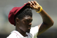 West Indies' Alzarri Joseph adjusts his hat while fielding against Australia on the 3rd day of their cricket test in Perth, Australia, Saturday, Dec. 3, 2022. (AP Photo/Gary Day)