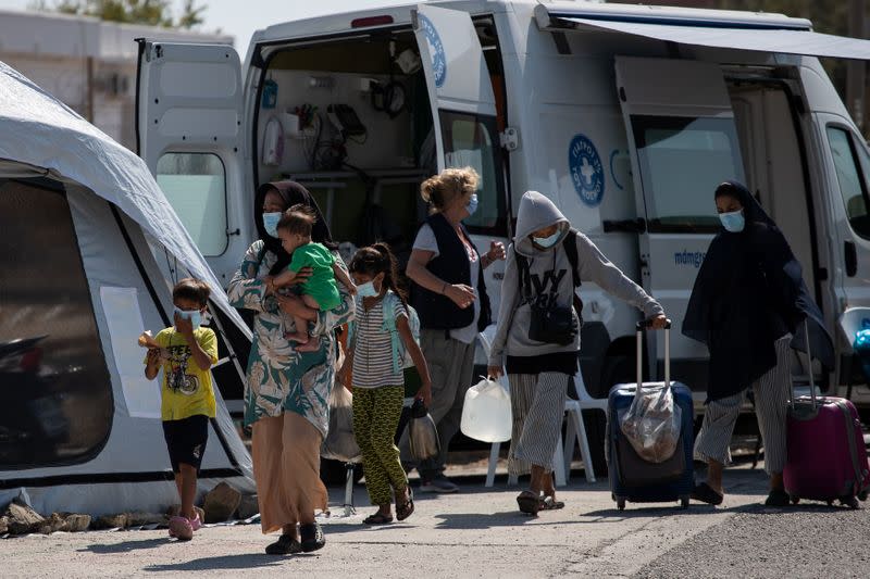 A family from the destroyed Moria camp for refugees and migrants arrives at a new temporary camp, on the island of Lesbos