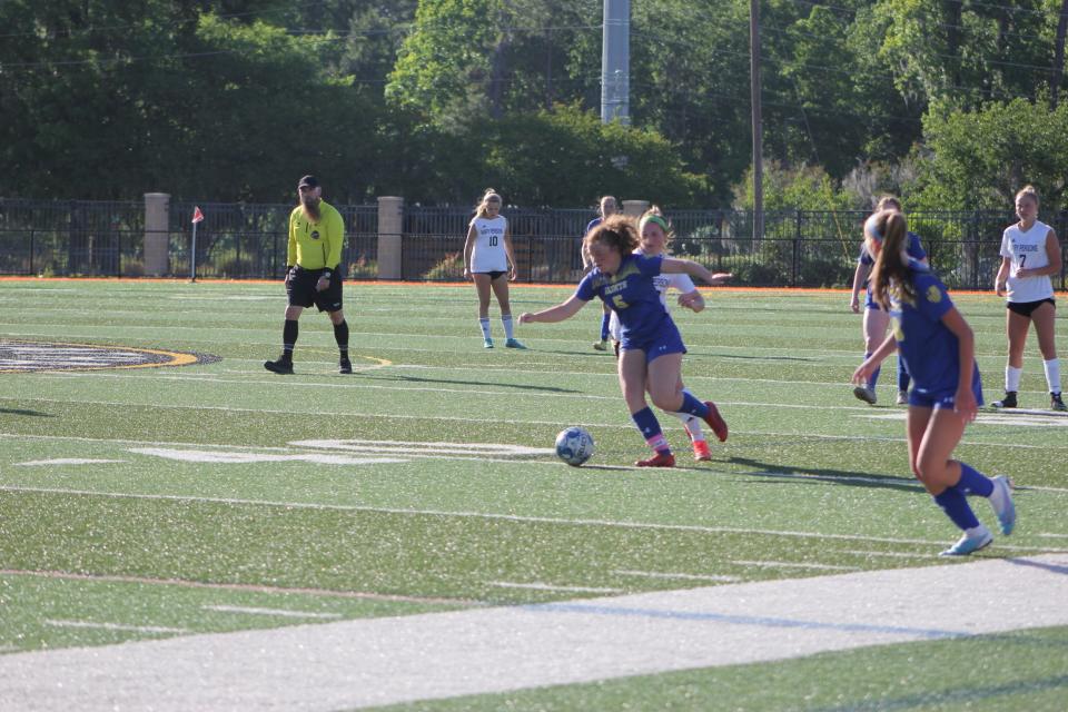 Camryn Woods of St. Vincent's wards off a defender in a playoff win over Mary Persons Monday.