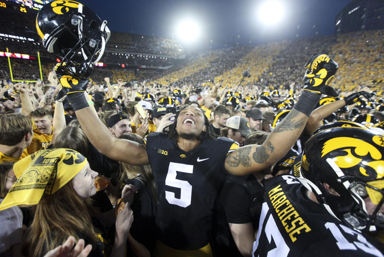 IOWA CITY, IOWA- OCTOBER 9:  Linebacker Jestin Jacobs #5 of the Iowa Hawkeyes celebrates with fans after the match-up against the Penn State Nittany Lions at Kinnick Stadium on October 9, 2021 in Iowa City, Iowa.  (Photo by Matthew Holst/Getty Images)