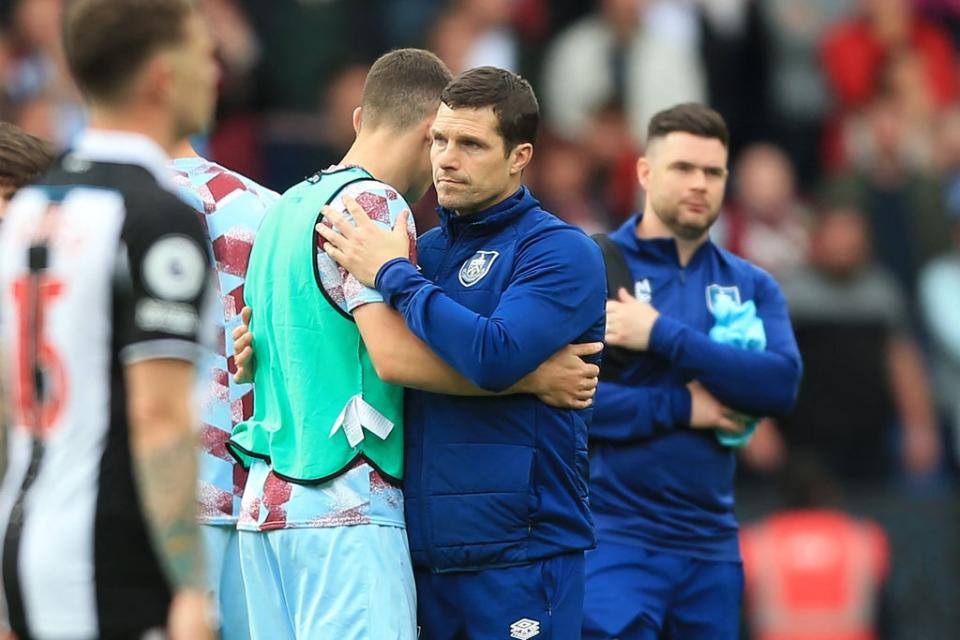 Burnley manager Mike Jackson consoles his players (AFP via Getty Images)