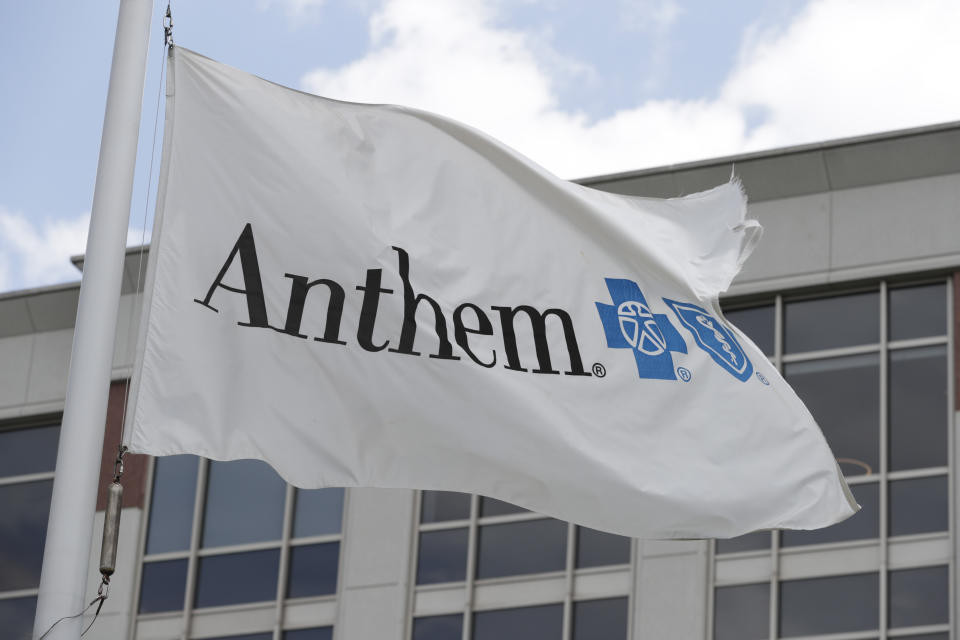 FILE - In this May 14, 2019, file photo a flag flies the outside of the corporate headquarters building of health insurance company Anthem is shown in Indianapolis. Anthem Inc. reports financial earns on Wednesday, Oct. 23. (AP Photo/Michael Conroy, File)