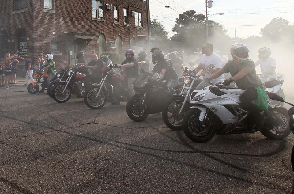 A large group of motorcyclists pay tribute to Matthew Parisi at the conclusion of his calling hours at Hennessy-Bagnoli-Moore Funeral Home on Sunday in Akron.