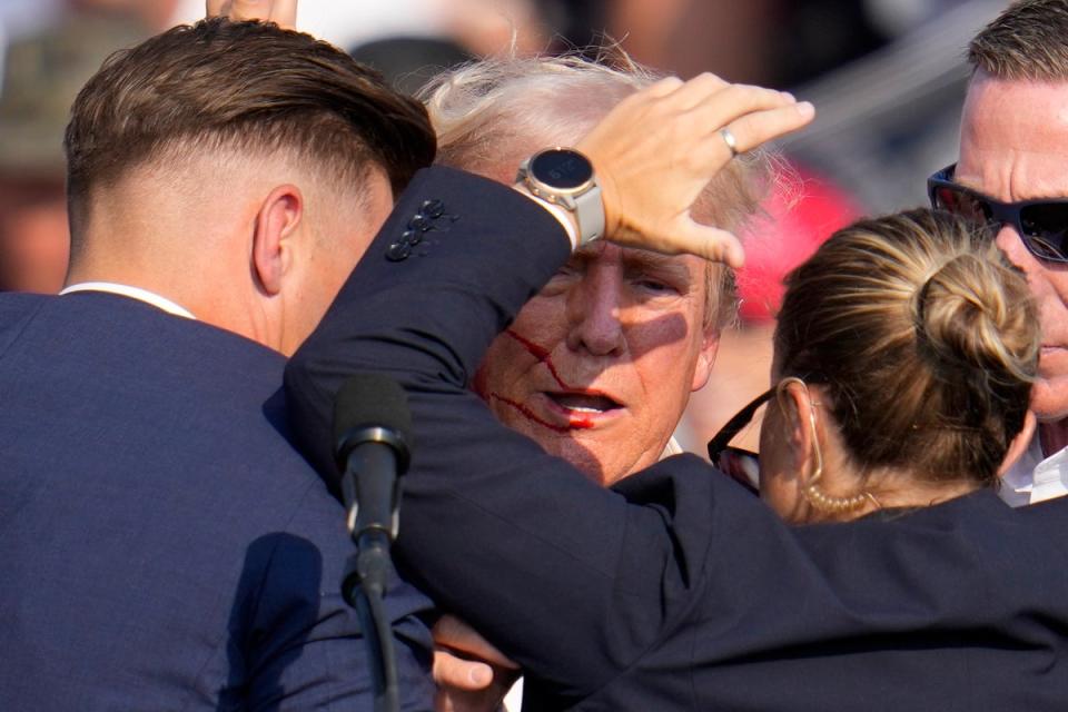 Secret Service agents surround Trump after he was shot in the ear at a campaign rally in Butler, Pennsylvania (Copyright 2024 The Associated Press. All rights reserved)