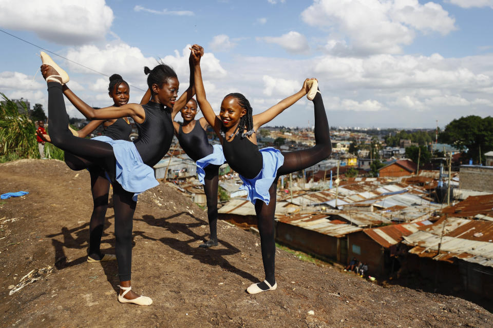 Young dancers practice by the Kenya - Uganda railway line, prior to the start of a Christmas ballet event in Kibera, the Kenyan capital's largest slum, Friday, Dec. 15, 2023. The ballet project is run by Project Elimu, a community-driven nonprofit that offers after-school arts education and a safe space to children in Kibera. (AP Photo/Brian Inganga)