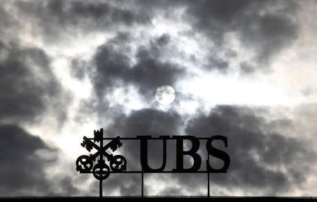 Dark clouds are seen over Swiss bank UBS logo on the company's buiding at Paradeplatz in Zurich, March 3, 2012. REUTERS/Christian Hartmann