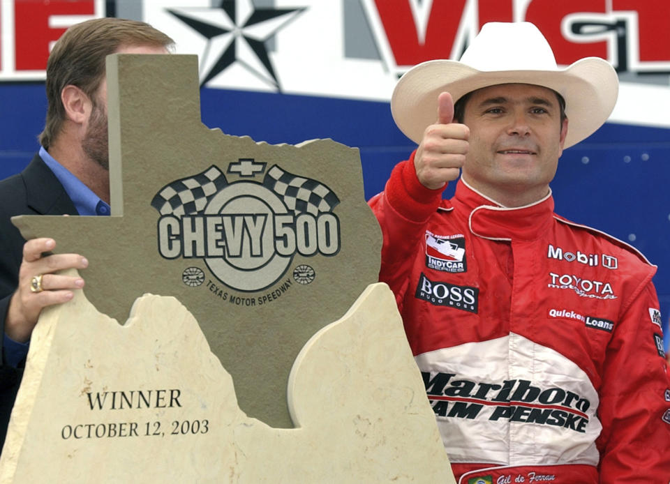 FILE - Gil de Ferran, of Brazil gives a thumbs up after winning the Indy Racing League auto race Oct. 12, 2003, at Texas Motor Speedway in Fort Worth, Texas. De Ferran, winner of the 2003 Indianapolis 500 and holder of the closed-course land speed record, died Friday, Dec. 29, 2023, while racing with his son at The Concourse Club in Florida, multiple former colleagues confirmed to The Associated Press. He was 56. (AP Photo/Tony Gutierrez, File)