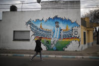 A mural depicting Lionel Messi decorates the wall of a building in the neighborhood of his hometown La Bajada, Argentina, Thursday, Aug. 27, 2020. Fans of Newell's Old Boys hope to lure him home following his announcement that he wants to leave Barcelona F.C. after nearly two decades with the Spanish club. (AP Photo/Natacha Pisarenko)