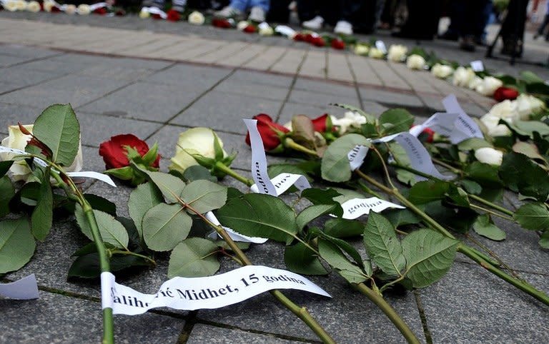 Flowers are seen, layed on pavement as several hundreds of Bosnian people, from different cities gather to commemorate "The White Banner Day" in Western-Bosnian town of Prijedor, on May 31, 2013