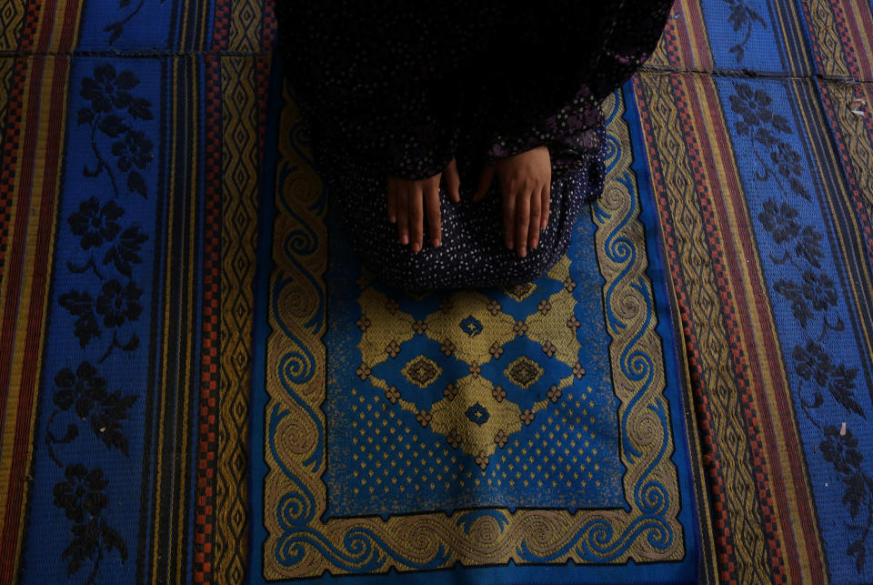 Palestinian high school student Wessal Abu Amra, 17, prays in her family house in Gaza City, Feb. 14, 2019. Abu Amra loves to go around Gaza with her friends, shopping and eating fast food. We have things that look alike famous brands but they are not the same," she said. "Despite wars and the bad economy, we are trying to find some joy. We know the reality we live in so we do things we love to get out of a bad mood," she said. (Photo: Samar Abo Elouf/Reuters)    