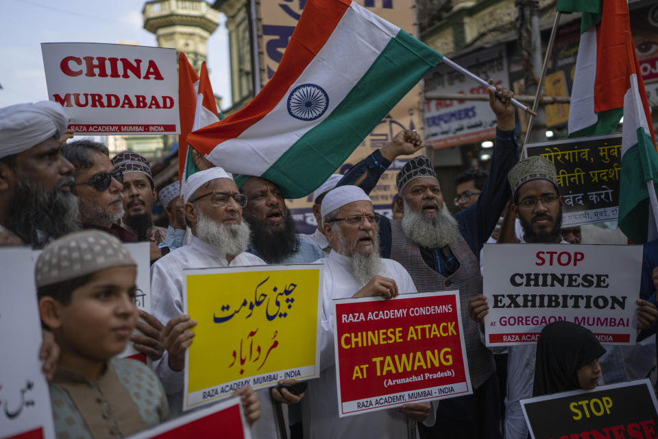 Indians hold placards as they shout slogans during a protest against China in Mumbai, India, Tuesday, Dec. 13, 2022. Soldiers from India and China clashed last week along their disputed border, India's defense minister said Tuesday, in the latest violence along the contested frontier since June 2020, when troops from both countries engaged in a deadly brawl. (AP Photo/Rafiq Maqbool)