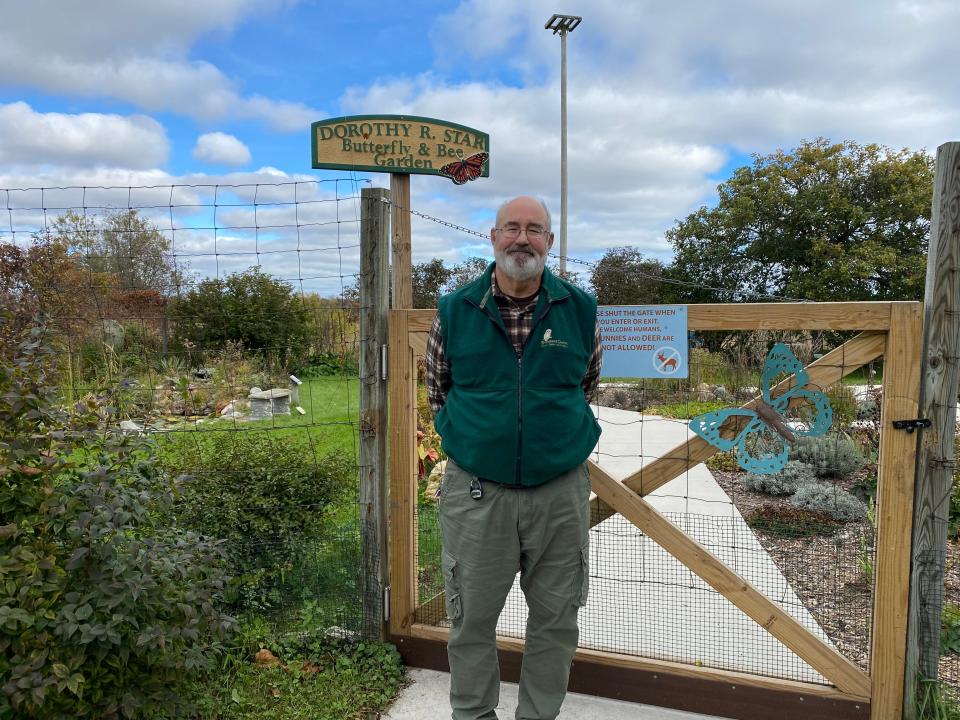 Woodland Dunes Nature Preserve Executive Director Jim Knickelbine stands outside the butterfly and bee garden at the Nature Center.