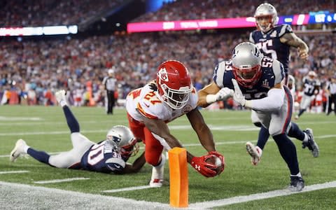 Kareem Hunt #27 of the Kansas City Chiefs dives for the pylon to score a 4-yard rushing touchdown during the fourth quarter against the New England Patriots at Gillette Stadium - Credit: (Maddie Meyer/Getty Images)