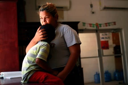 Honduran migrant Denia Carranza and her son Robert, who have given up their U.S. asylum claim under the Migrant Protection Protocol (MPP), pose for a photo at Casa del Migrante migrant shelter, in Ciudad Juarez