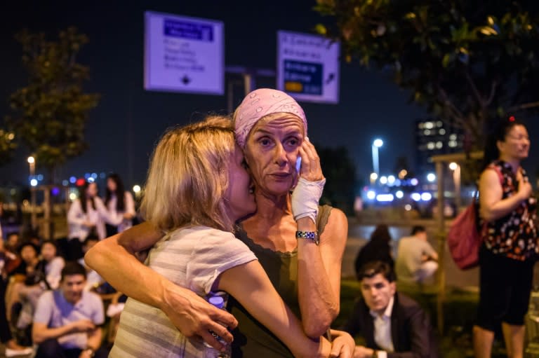 Passengers embrace outside Istanbul's Ataturk airport after a triple suicide bombing and gun attack on June 28, 2016