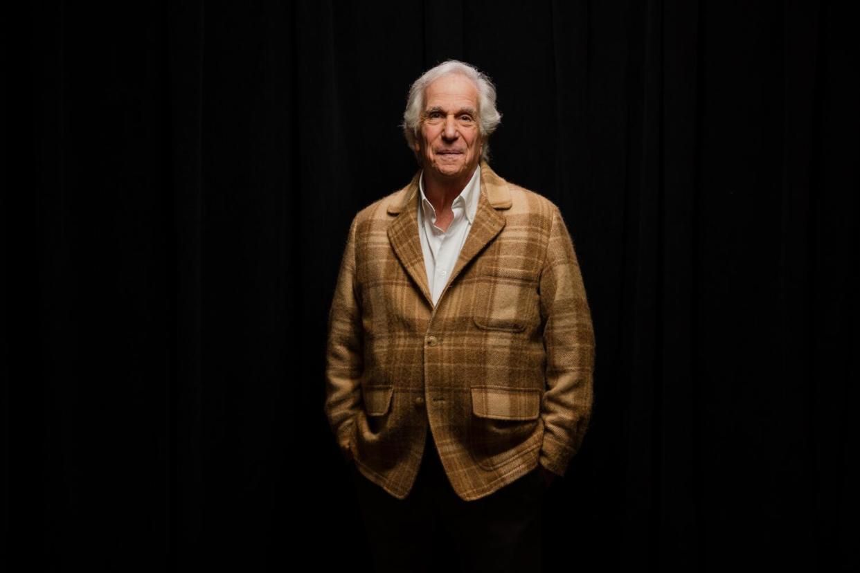 A man stands against a black background.