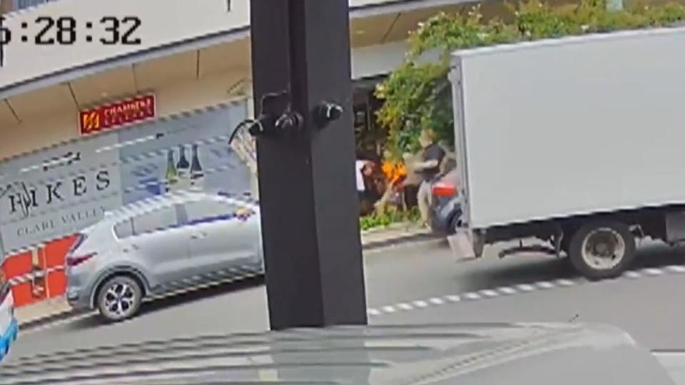 CCTV footage shows the moment three locals chase the man after he allegedly stabbed a woman multiple times. Picture: Channel 9