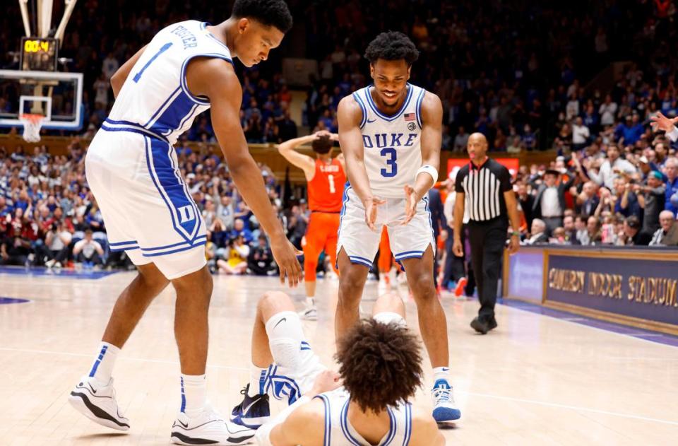 Duke’s Caleb Foster (1) and Jeremy Roach (3) head to lift up Tyrese Proctor (5) after Proctor was fouled while shooting with one second left in the game during Duke’s 72-71 victory over Clemson at Cameron Indoor Stadium in Durham, N.C., Saturday, Jan. 27, 2024.