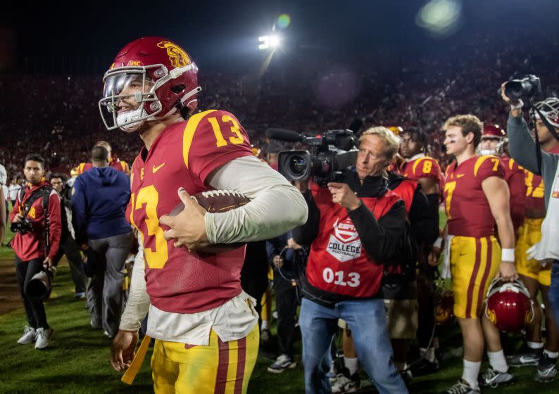 USC quarterback Caleb Williams carries the game ball as he leaves the field after a win over Notre Dame on Nov. 26, 2022.