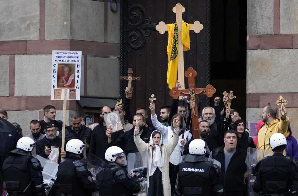 Anti-LGTBQ protesters shout slogans in front of St. Marco church during the European LGBTQ pride march in Belgrade, Serbia, Saturday, Sept. 17, 2022. Serbian police have banned Saturday's parade, citing a risk of clashes with far-right activists. (AP Photo/Darko Vojinovic)