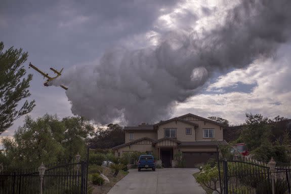 A Super Scooper CL-415 firefighting aircraft from Canada makes a drop to protect a house on September 3, 2017 near Burbank, California. At nearly 7,000 acres, the fire is the biggest fire in terms of acreage in Los Angeles County history.