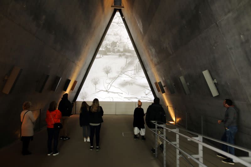 Visitors look at part of an exhibition in the Holocaust History Museum at the Yad Vashem World Holocaust Remembrance Center in Jerusalem