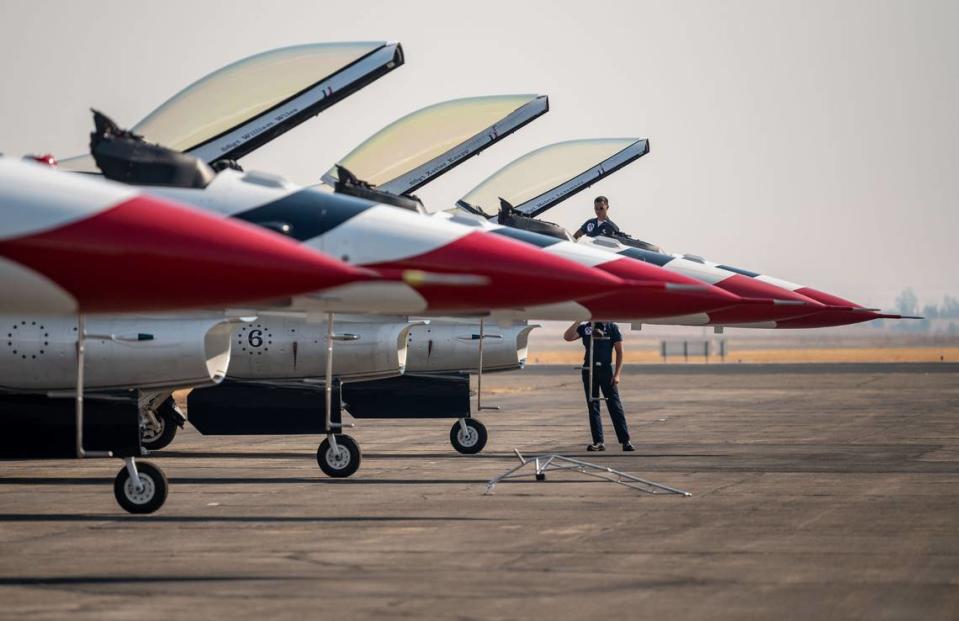 Melvin Laxamana, top, and Charles Bolles, staff sergeants and crew chiefs with the U.S. Air Force Air Demonstration Squadron “Thunderbirds,” prepare F-16 Fighting Falcons for flight at the start of the California Capital Airshow on Friday, Sept. 24, 2021, at Mather Airport in Sacramento.