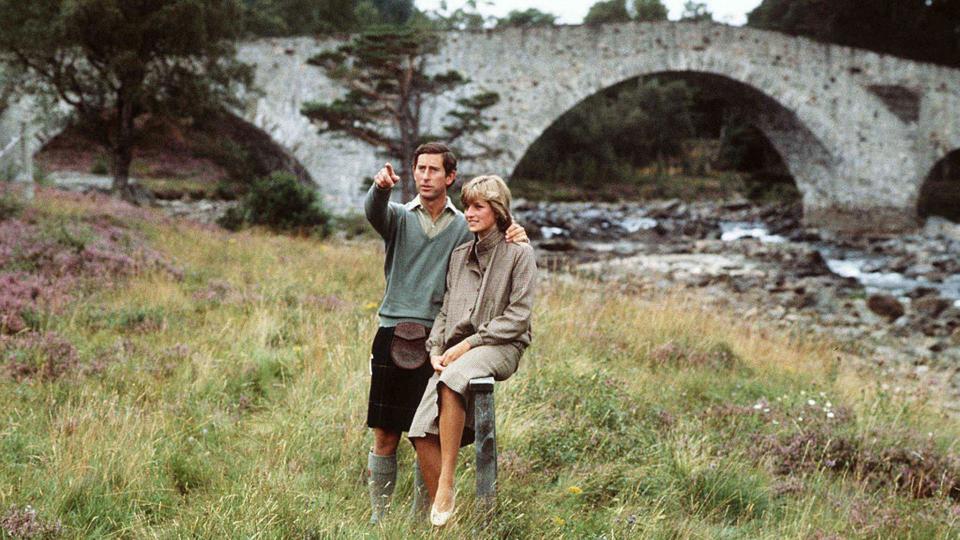 Prince Charles, Prince of Wales and Diana, Princess of Wales, wearing a suit designed by Bill Pashley, pose for a photo on the banks of the river Dee in the grounds of Balmoral Castle during their honeymoon on August 19, 1981 in Balmoral, Scotland. (Photo by Anwar Hussein/Getty Images)