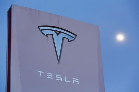 Signage is displayed outside of Tesla Motors before the Tesla Energy Powerwall Home Battery event in Hawthorne, California April 30, 2015. REUTERS/Patrick T. Fallon