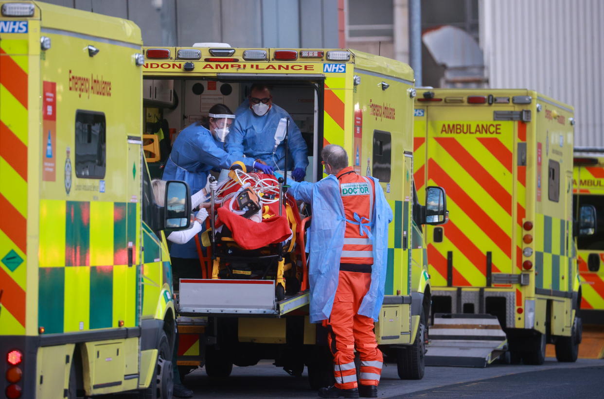 Medics transport a patient from an ambulance to the Royal London Hospital as the spread of the coronavirus disease (COVID-19) continues in London, Britain, January 2, 2021. REUTERS/Hannah McKay