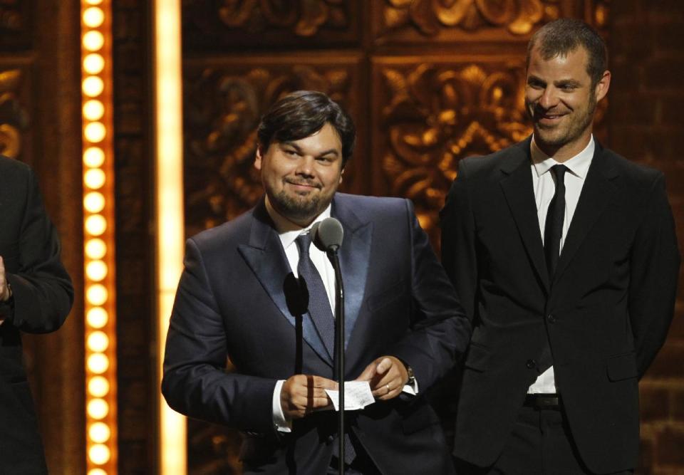 FILE - This June 12, 2011 file photo shows songwriter Robert Lopez, left, and Matt Stone accepting the award for Best Book of a Musical for "The Book of Mormon" during the 65th annual Tony Awards in New York. Lopez, who helped create "Avenue Q" and "The Book of Mormon," is up for an Academy Award next month along with his co-writing partner and wife, Kristen Anderson-Lopez, for best song for "Let it Go" from the animated film "Frozen." (AP Photo/Jeff Christensen, File)