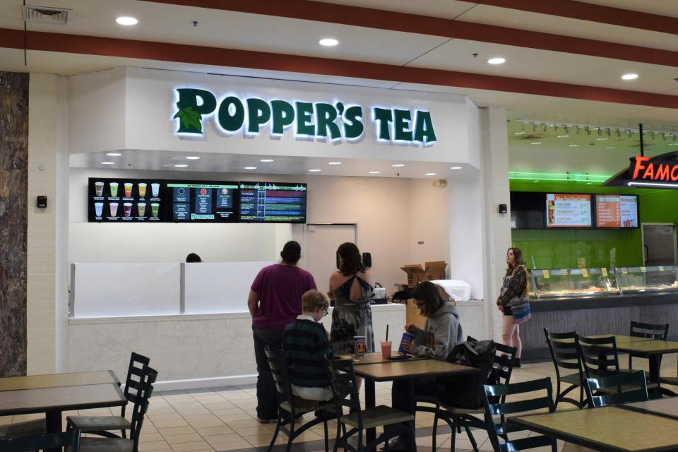 Customers look at the menu at Popper's Tea in the Northwoods Mall. The shop opened on June 24, 2023.