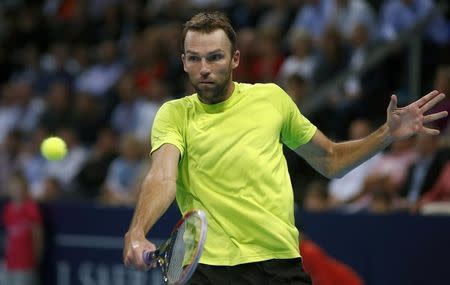 Ivo Karlovic of Croatia returns the ball to Switzerland's Roger Federer during their semi-final match at the Swiss Indoors ATP tennis tournament in Basel October 25, 2014. REUTERS/Arnd Wiegmann