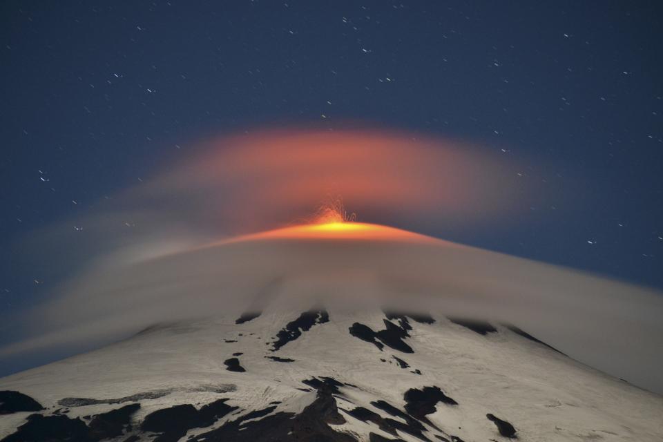 Smoke and lava spew from the Villarrica volcano as seen from Pucon town in the south of Santiago