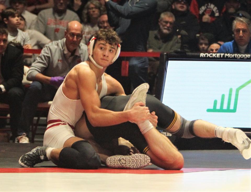 Wisconsin's Dean Hamiti executes a takedown against Iowa's Patrick Kennedy during a dual at the UW Field House in Madison on Jan. 22.