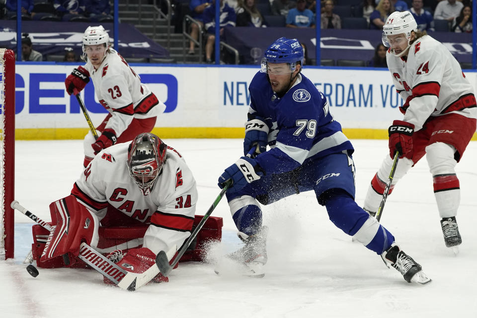 Carolina Hurricanes goaltender Petr Mrazek (34) stops a shot by Tampa Bay Lightning left wing Ross Colton (79) during the second period in Game 4 of an NHL hockey Stanley Cup second-round playoff series Saturday, June 5, 2021, in Tampa, Fla. (AP Photo/Chris O'Meara)