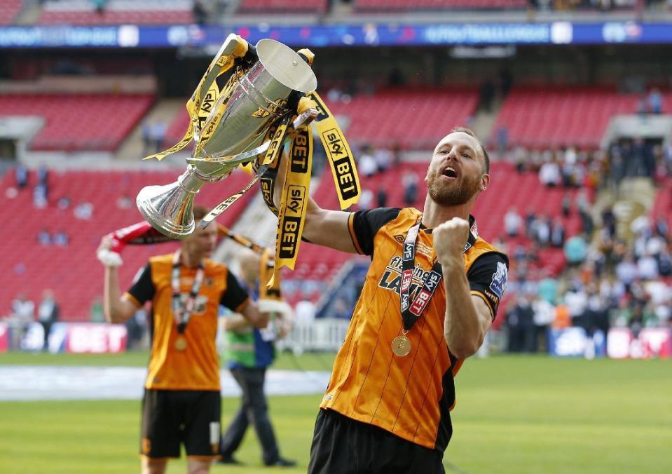 Britain Soccer Football - Hull City v Sheffield Wednesday - Sky Bet Football League Championship Play-Off Final - Wembley Stadium - 28/5/16 Hull City's David Meyler celebrates with the trophy after winning promotion back to the Premier League Action Images via Reuters / Andrew Couldridge Livepic EDITORIAL USE ONLY. No use with unauthorized audio, video, data, fixture lists, club/league logos or "live" services. Online in-match use limited to 45 images, no video emulation. No use in betting, games or single club/league/player publications. Please contact your account representative for further details.