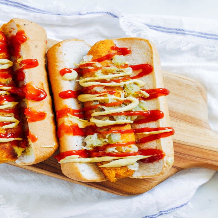 Hot dogs in a bun with ketchup, mustard, and relish