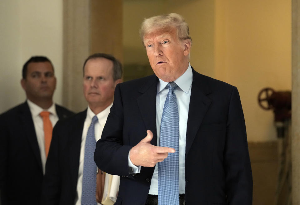 Former President Donald Trump comments to the media during a break of his civil business fraud trial at New York Supreme Court, Wednesday, Oct. 18, 2023, in New York. (AP Photo/Seth Wenig)