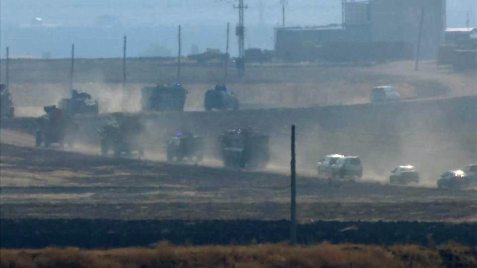 Military vehicles move in convoy along a road in Sevimli, Mardin Province, Turkey, Friday Nov. 1, 2019. Turkey and Russia launched joint patrols Friday in northeastern Syria, under a deal that halted a Turkish offensive against Syrian Kurdish fighters who were forced to withdraw from the border area following Ankara's incursion. (AP Photo)