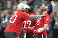 AFC tight end Dawson Knox of the Buffalo Bills, right, celebrates a two-point conversion with teammates center Mitch Morse of the Buffalo Bills, left, and running back Derrick Henry (22) of the Tennesse Titans during the flag football event at the NFL Pro Bowl, Sunday, Feb. 5, 2023, in Las Vegas. (AP Photo/John Locher)