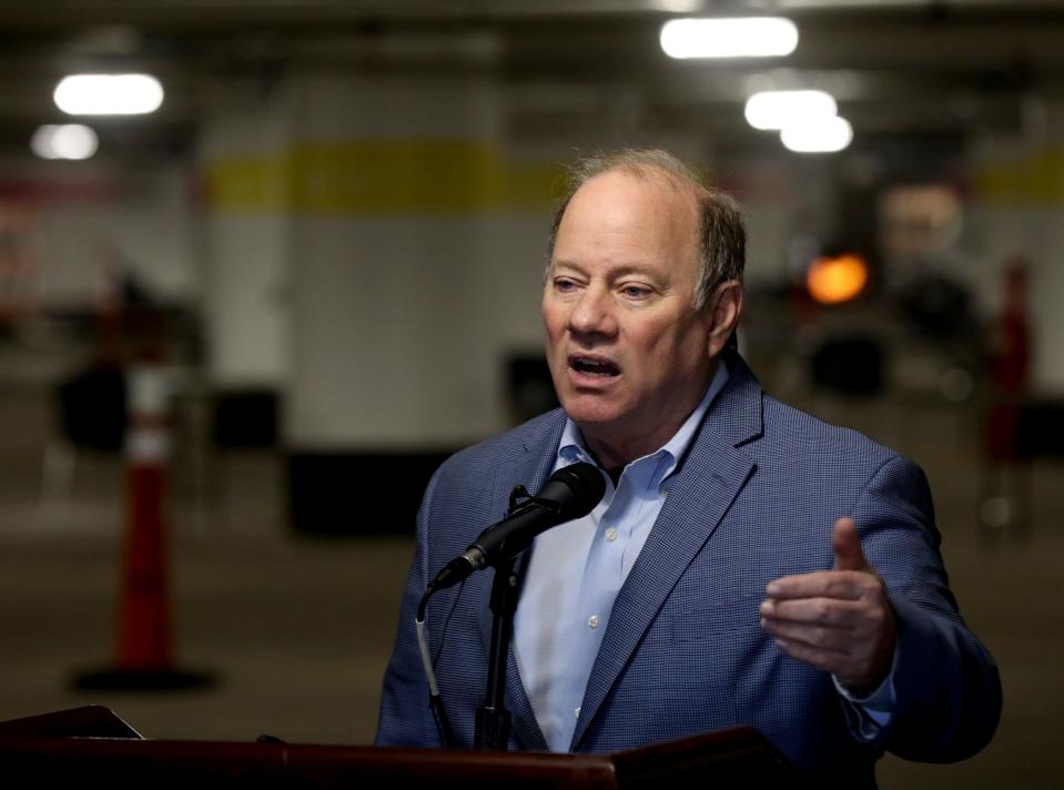 Detroit Mayor Mike Duggan talks with the media in the underground parking lot at the TCF Center in Detroit where the first shots of the Covid-19 vaccine were being given out to people 75 and older behind him on Wednesday, January 13, 2021 Up to 400 vaccines were being distributed in a quick and efficient drive up system. As the days go on more vaccines will be given out.