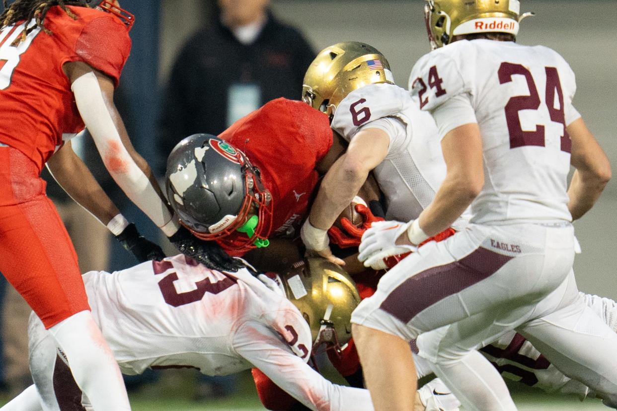 Dec 1, 2023; Canton, Ohio, USA;
Bishop Watterson's Dominic Purcell (6) and Joe Hayes (23) tackle Toledo Central Catholic's Marquan Braswell (22) during their game on Friday, Dec. 1, 2023 at Tom Benson Hall of Fame Stadium for the Division III state finals.