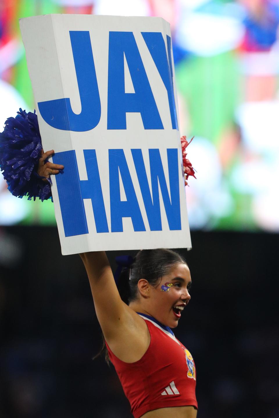 A Kansas football cheerleaders holds up a sign during a game Aug. 29 against Lindenwood at Children's Mercy Park in Kansas City, Kansas.